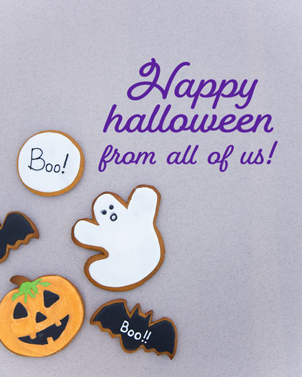 Greeting card with cookies shaped like ghost, pumpkin, and bats, featuring 'Happy Halloween from all of us!' text.
