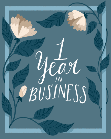Hand-lettered “1 Year in Business” text framed by cream flowers and teal leaves on blue