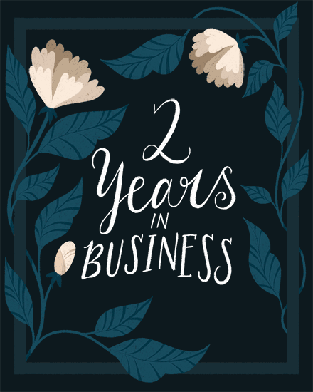 Hand-lettered “2 Years in Business” on navy background with teal leaves and cream flowers