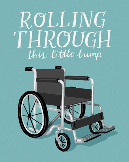 Teal design with illustrated wheelchair and hand-lettered text, “Rolling Through this little bump.”