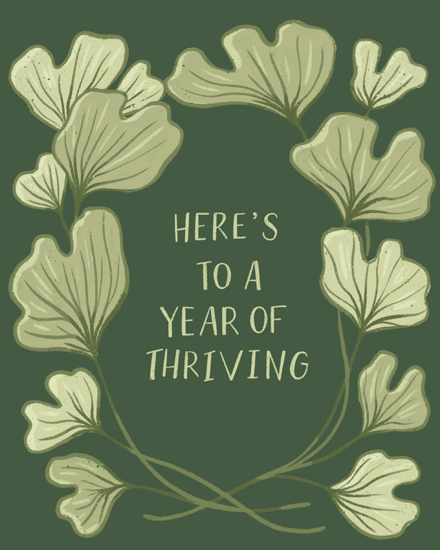 Green ginkgo leaf wreath on dark background with text “Here’s to a year of thriving”.