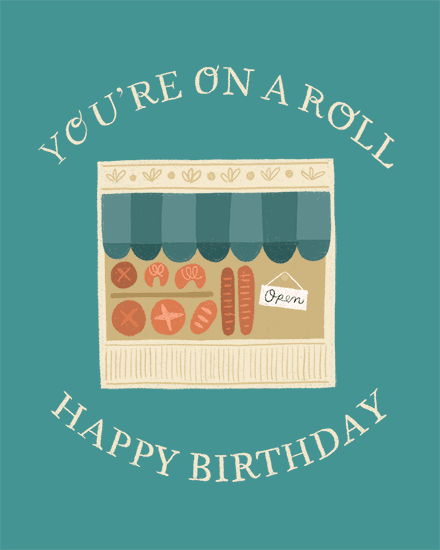 Teal birthday greeting with illustrated bakery window and text “You’re On A Roll”