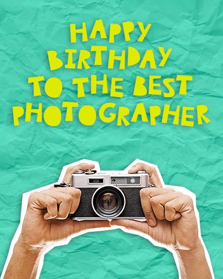 Yellow birthday text on teal background above hands holding a vintage camera