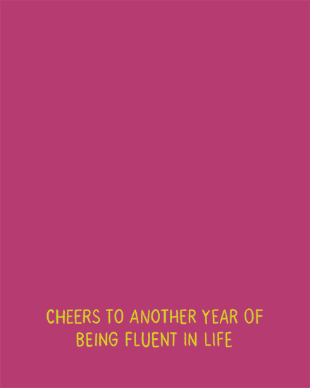 Magenta background with yellow text reading cheers to another year of being fluent in life