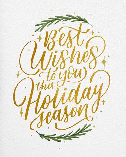 Gold calligraphy with green foliage on a holiday greeting card