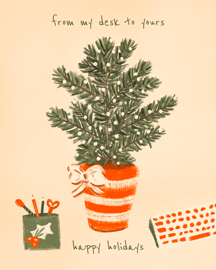 Potted pine tree with lights and ribbon, holiday text, orange keyboard.