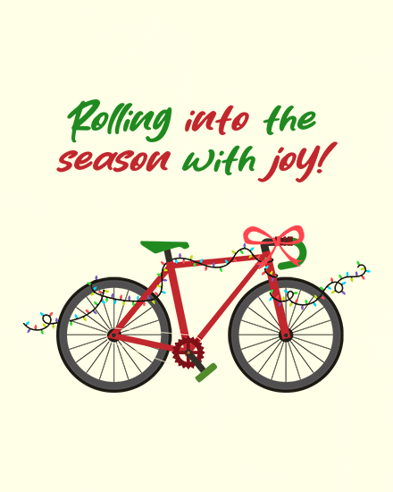 Red bicycle with festive lights and bow, cheerful holiday message.