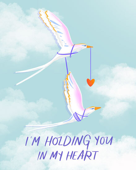 Two birds in flight holding a red heart, with soft clouds.