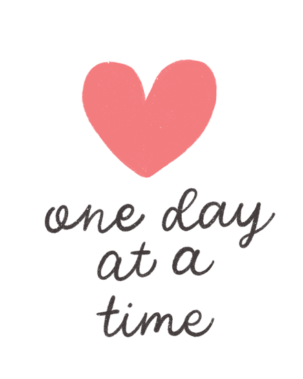 Coral heart above handwritten phrase "one day at a time" on white background